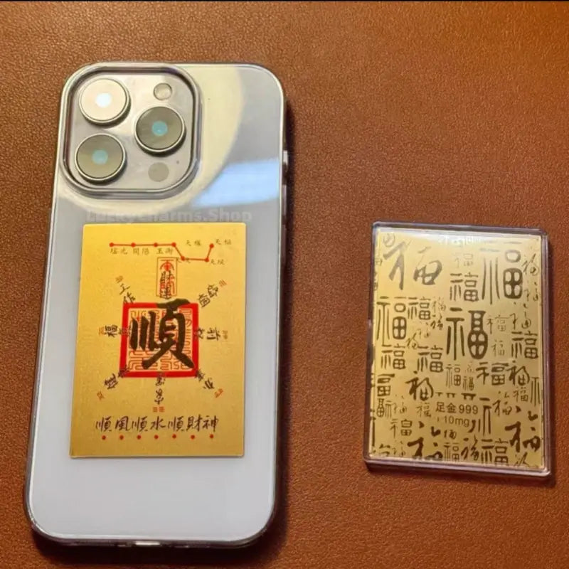 999 pure gold foil phone sticker featuring smooth fortune Chinese calligraphy charm on a clear phone case.