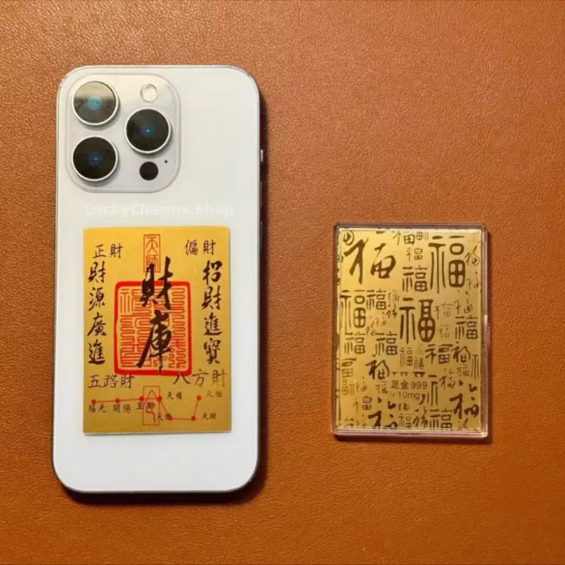 999 pure gold foil wealth charm phone sticker displaying wealth repository talisman on phone cover.
