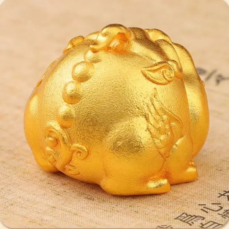 Back angle of 24K gold-plated Pixiu charm showing detailed tail and ancient coin engravings.