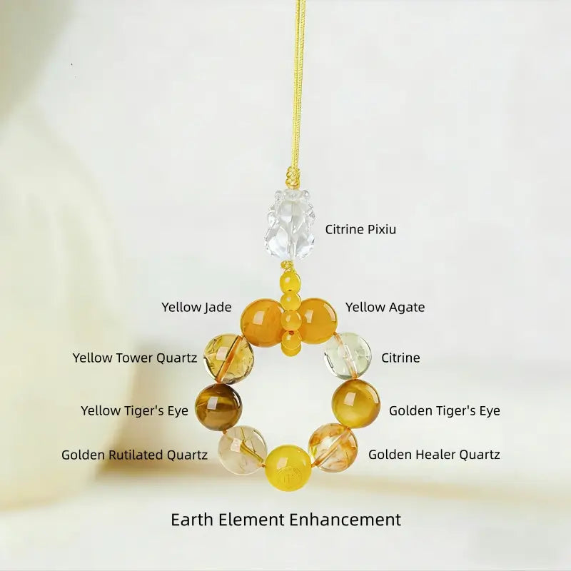 Earth Element Pixiu phone charm made with citrine Pixiu, yellow jade, golden rutilated quartz, and yellow agate.