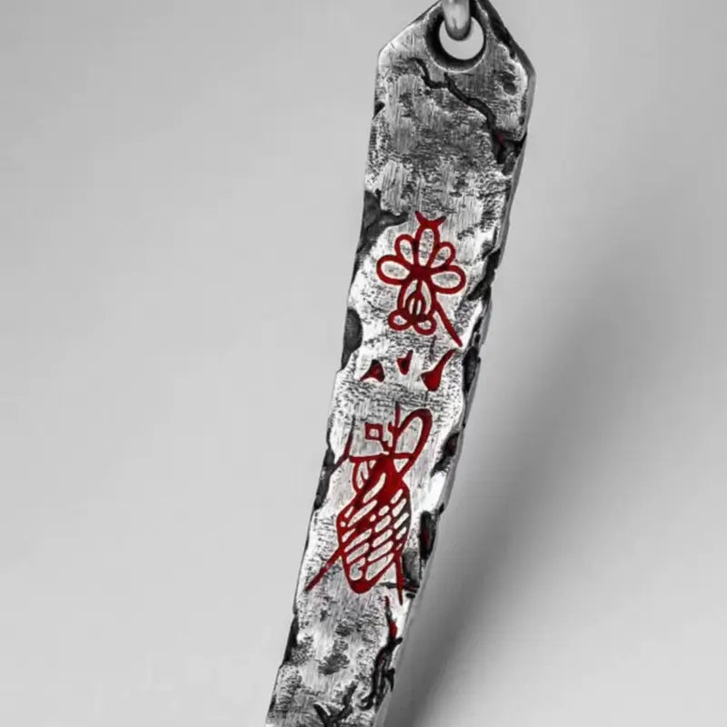 Detailed view of textured Tibetan silver bracelet bar with red inlaid Chinese symbols.
