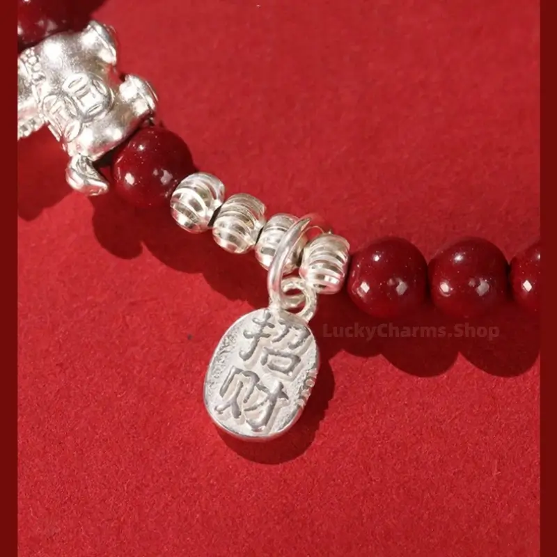 Fine 999 silver Chinese fortune charm tag engraved with Zhao Cai on natural red cinnabar beaded bracelet.