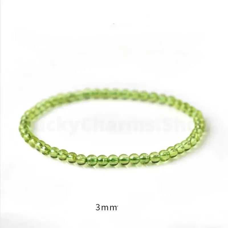 A dainty 3mm natural peridot single-strand minimalist bracelet on a pure white background, labeled with "3mm" text for delicate sizing.