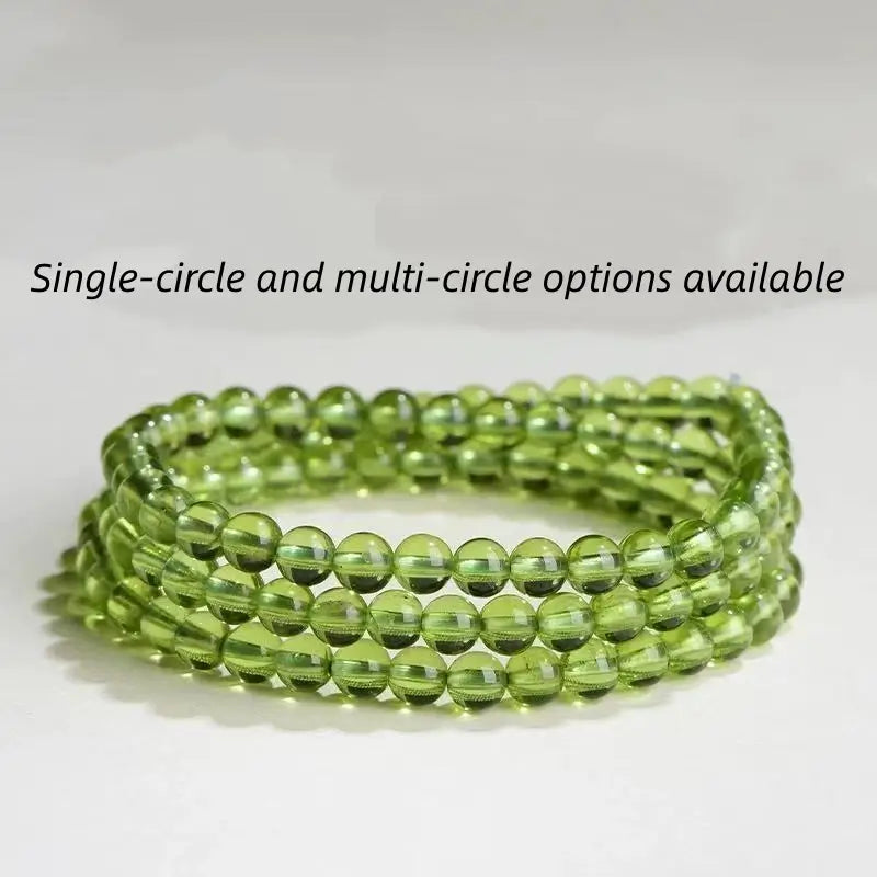 A three-strand multi-circle wrap bracelet made of 4.5mm natural peridot gemstone beads, showcasing a vibrant lime green color on a light neutral background.