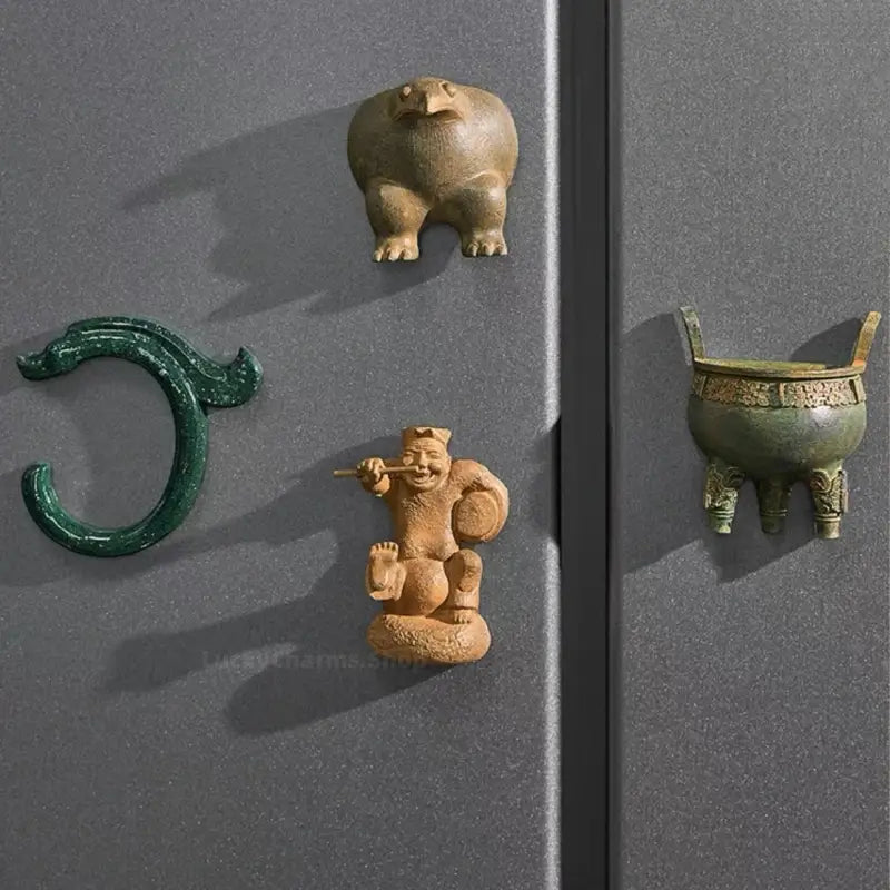 Four Chinese museum artifact 3D resin magnets displayed on a dark metallic refrigerator door.