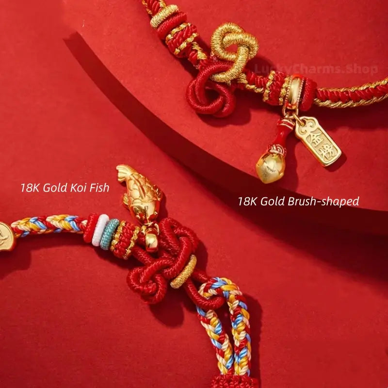 Detailed view of 18K gold koi fish and brush-shaped charm pendants on woven red string bracelets.