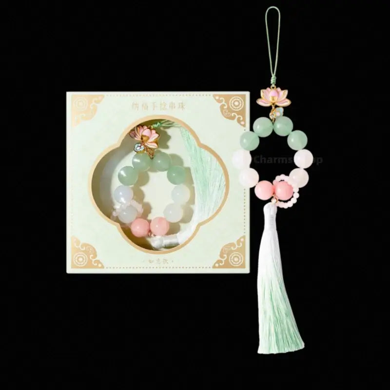 Palace Museum pastel green aventurine lotus tassel phone charm with pale green gift box.