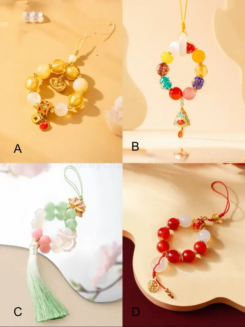Four style variants A, B, C, and D of Palace Museum beaded phone chains with lucky charms.