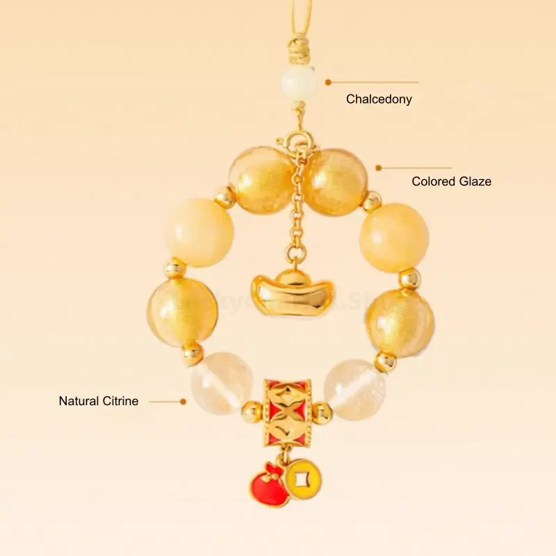 Close-up diagram showing natural citrine, chalcedony, and colored glaze beads on yellow ingot phone charm.
