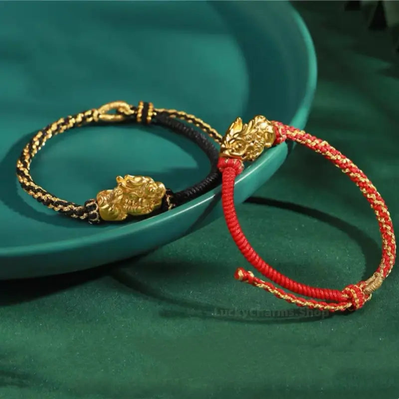 Palace Museum gold-plated Pixiu lucky couple bracelets in black and red hand-woven threads.
