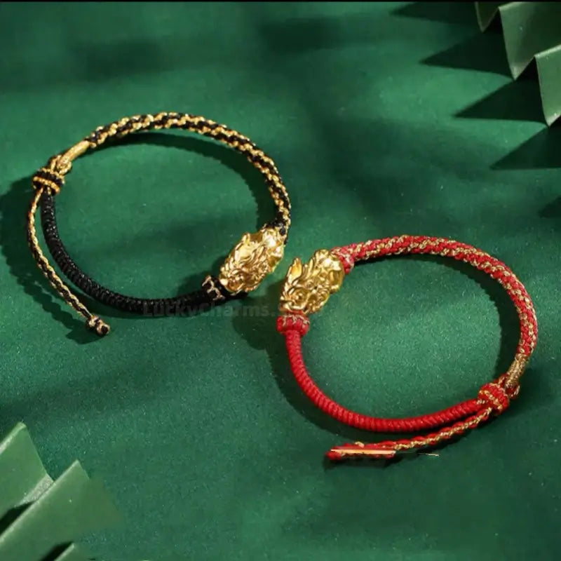 Matching black and red Palace Museum gold-plated Pixiu braided cord bracelets for couples.