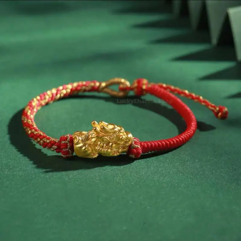 Red and gold braided lucky thread bracelet with a Palace Museum gold-plated Pixiu charm.