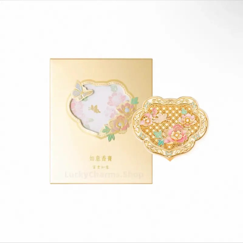 Palace Museum gold enamel peony Ruyi solid perfume compact displayed next to its elegant gold gift box.