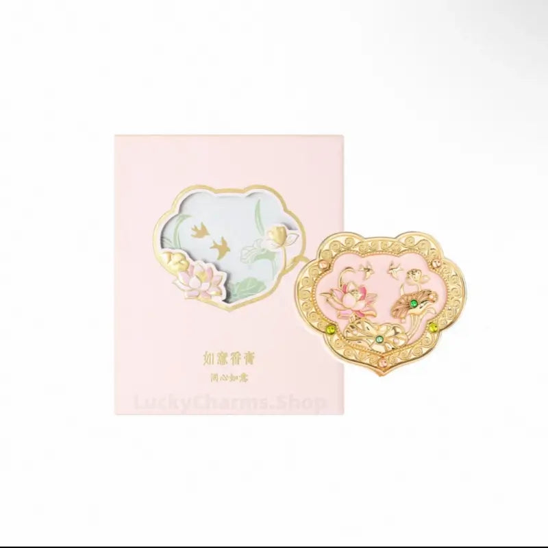 Palace Museum pink enamel lotus Ruyi solid perfume compact paired with matching light pink gift box.