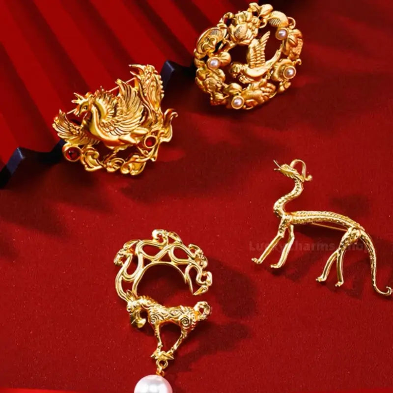 Four Shaanxi History Museum gold-plated cultural relic brooches on red background.