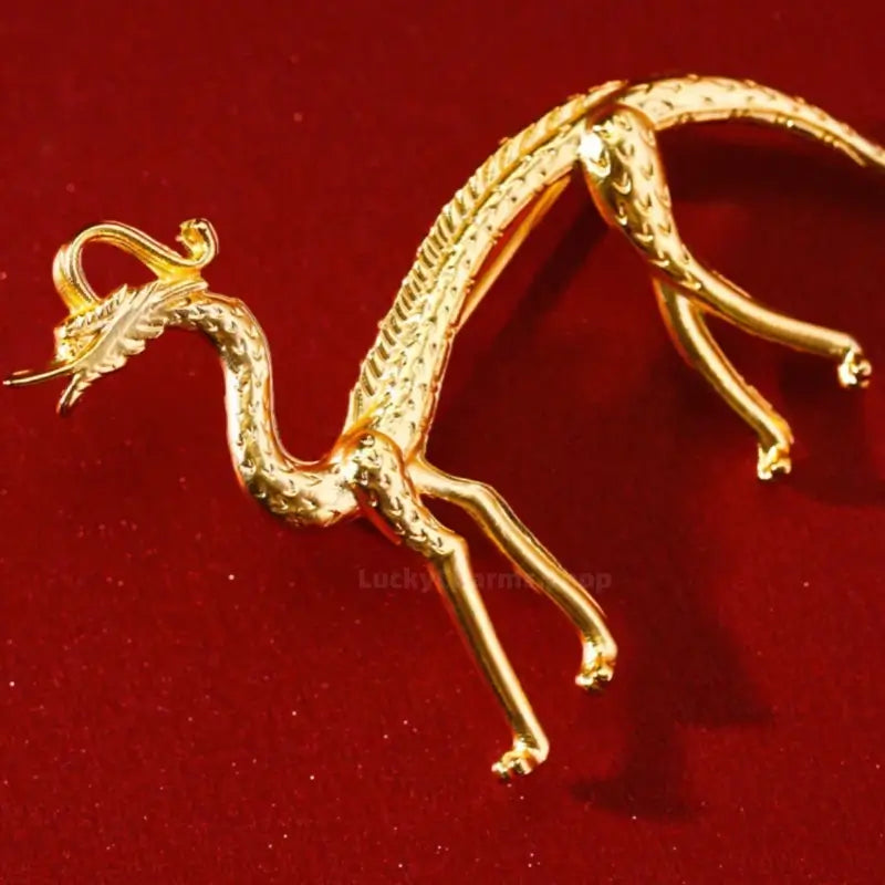 Detailed view of gold-plated walking dragon brooch inspired by Chinese museum relics.
