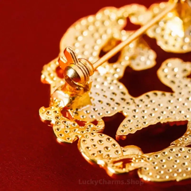 Back clasp and pin detail of gold-plated Shaanxi History Museum cultural relic brooch.
