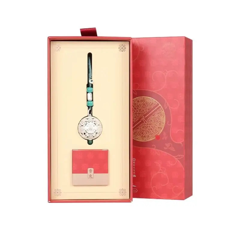 Silver spherical sachet pendant packaged in a luxurious red gift box with incense refill accessories.