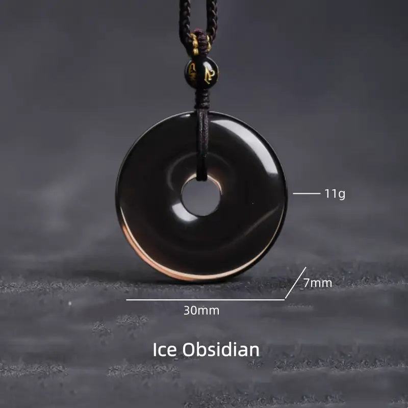 Translucent ice obsidian peace buckle donut pendant necklace showing dimensions and weight info.