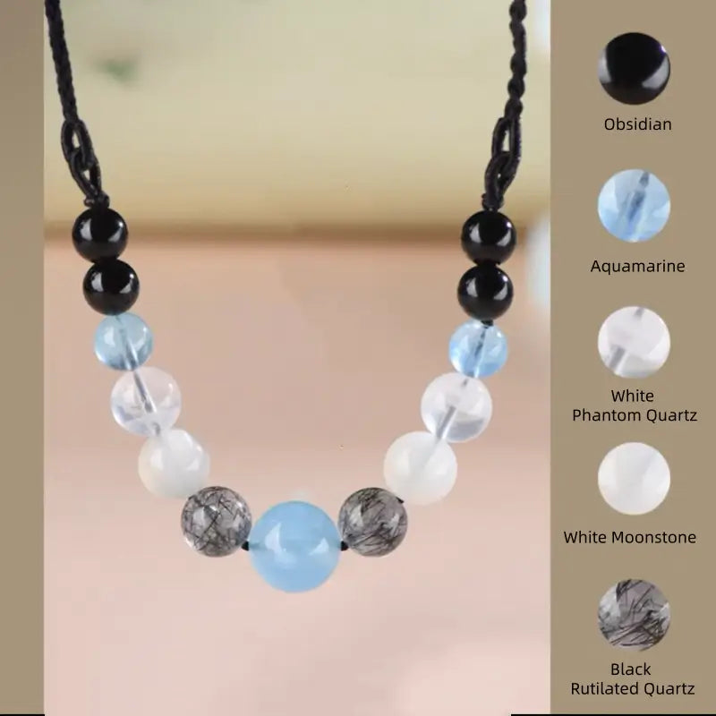 Metal Water element necklace featuring obsidian, aquamarine, white moonstone, and black rutilated quartz.