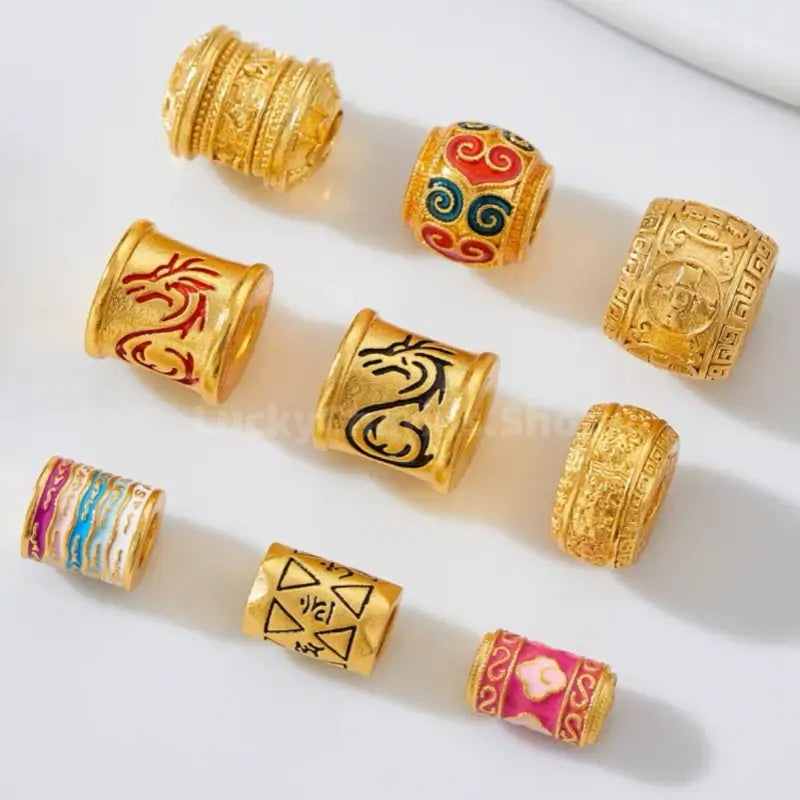 Assortment of gold-plated dragon totem and lucky enamel barrel beads for DIY jewelry making.