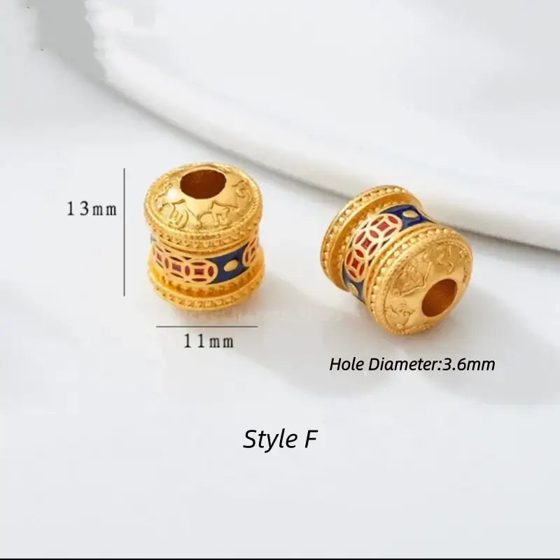 Style F gold-plated prayer wheel barrel bead with blue enamel accent. 13x11mm, 3.6mm hole.