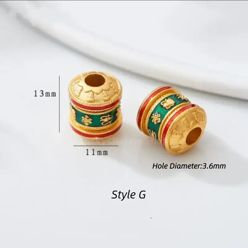 Style G gold-plated prayer wheel bead with green and red enamel details. 13x11mm, 3.6mm hole.