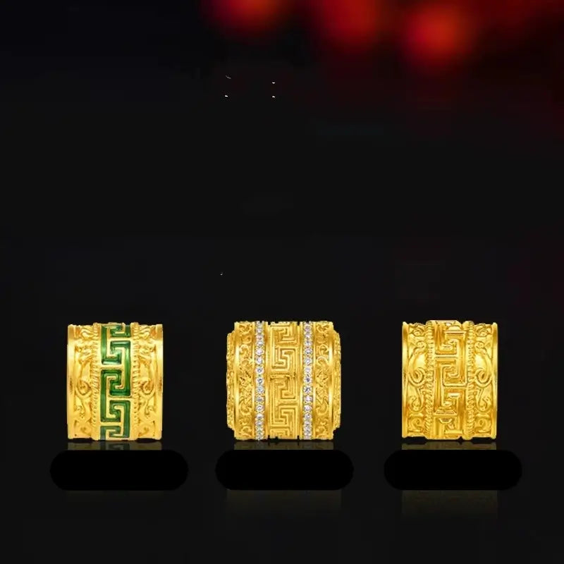 Three gold-plated meander pattern Lu Lu Tong cylinder beads with enamel and cubic zirconia accents.