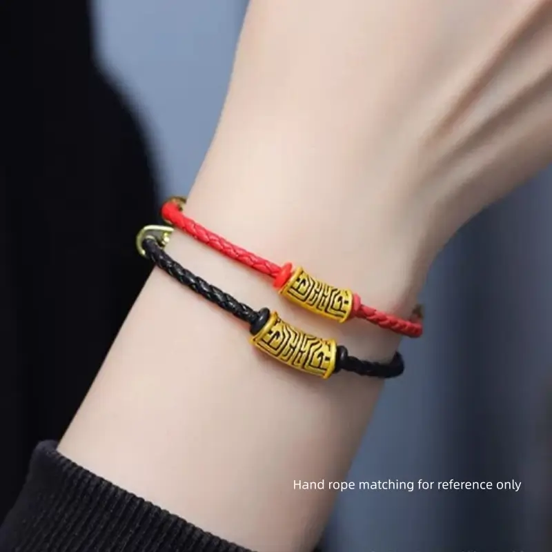 Person wearing red and black braided cord bracelets featuring gold-plated Taotie pattern Lu Lu Tong beads.