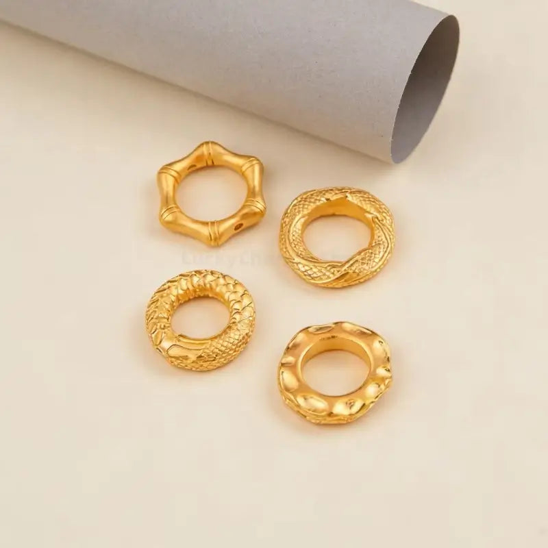 Collection of 4 gold-plated auspicious pattern peace buckle charms for DIY bracelet making.