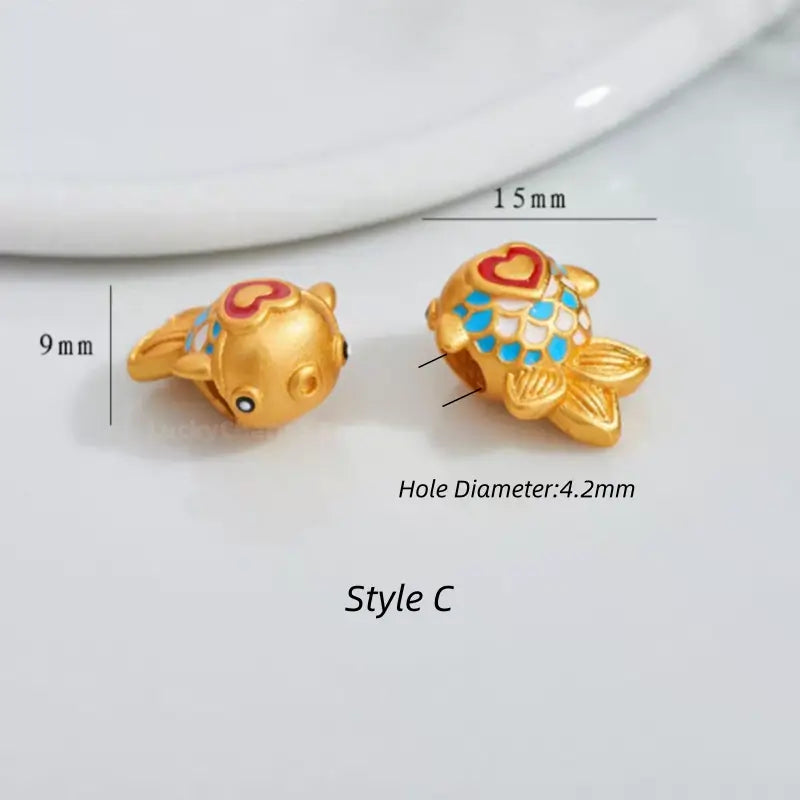 Gold fish charm bead with heart detail and blue enamel scales, 15mm x 9mm (Style C).