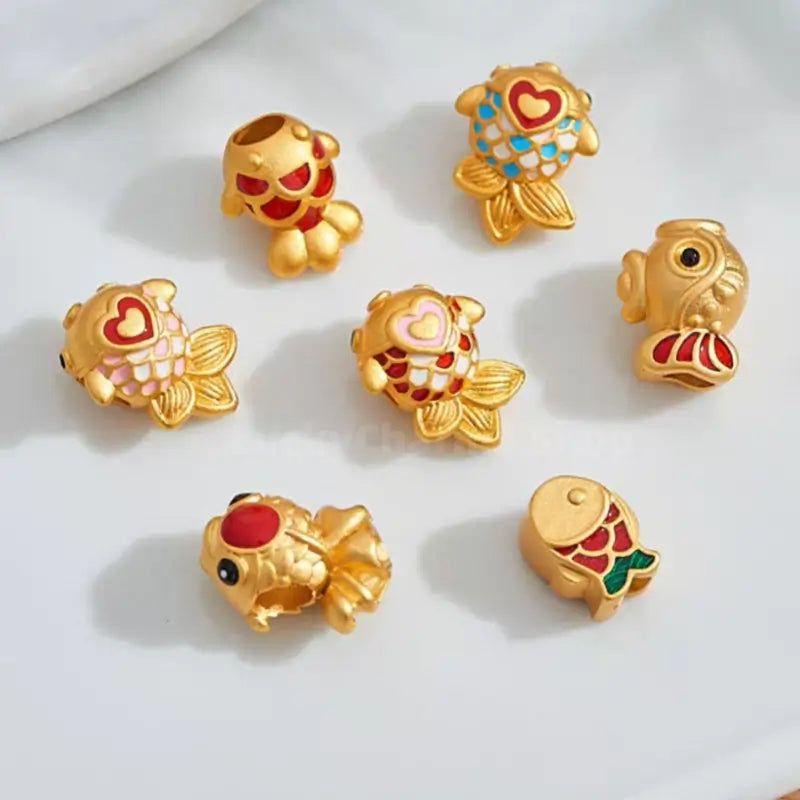 Assorted gold-plated koi fish enamel spacer beads with hole for DIY jewelry making.