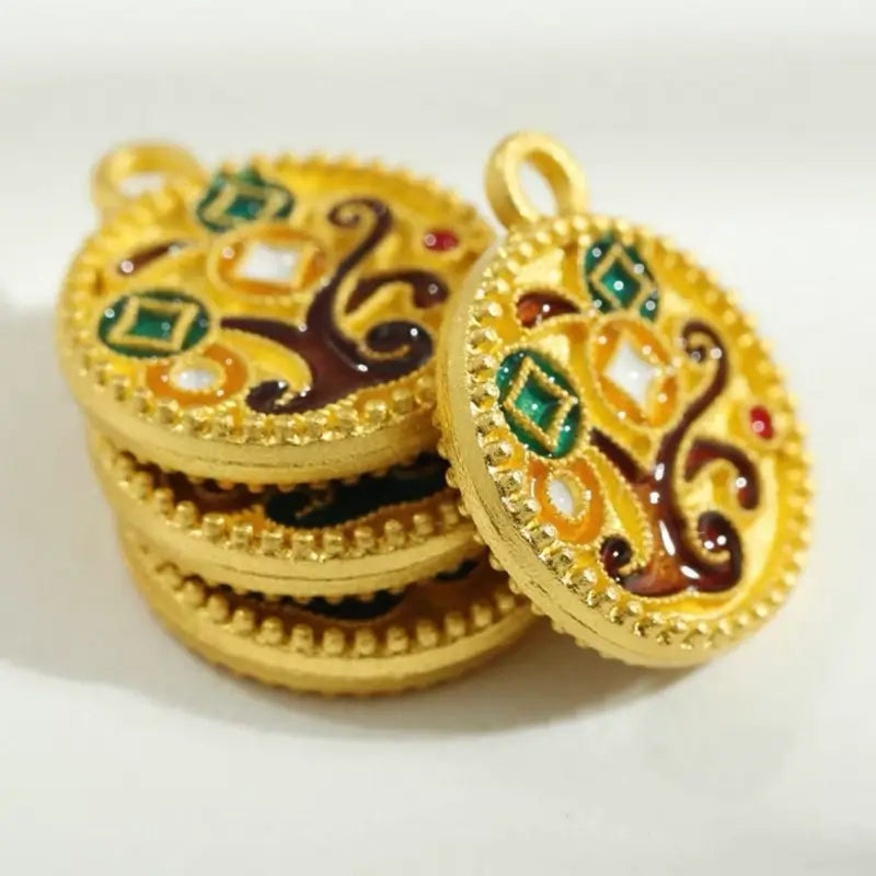 Stacked Chinese enamel money tree charms showing side profile and gold texture.