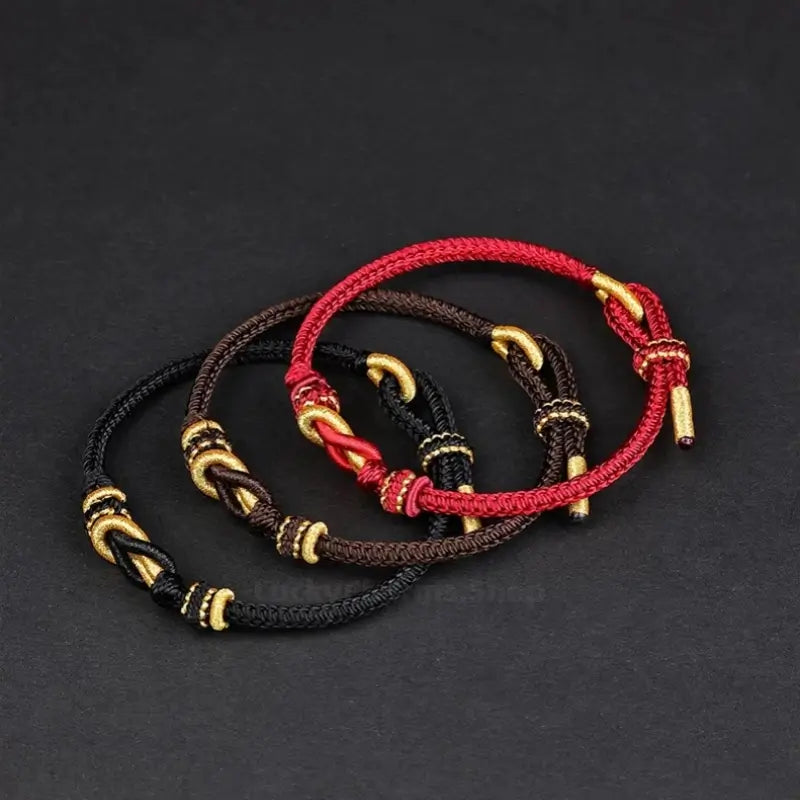 Black, brown, and red braided couple bracelets featuring gold Never Part knot details.