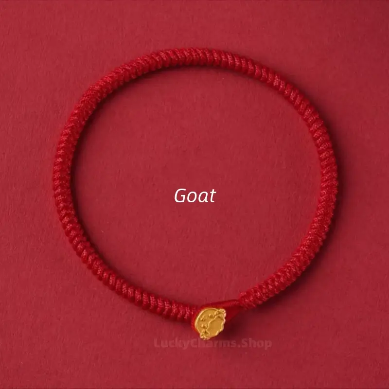 Red braided cord lucky bracelet accented with a gold Goat Chinese zodiac animal clasp on a red background.