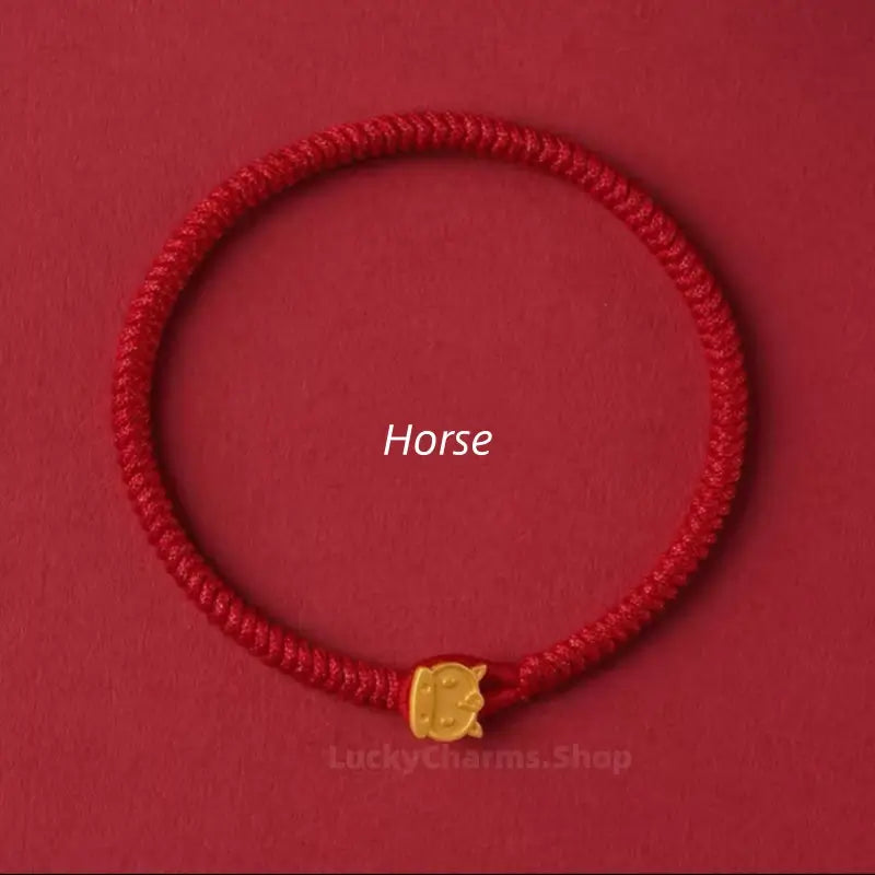 Handwoven red string lucky bracelet featuring a gold Horse Chinese zodiac animal clasp on a red background.