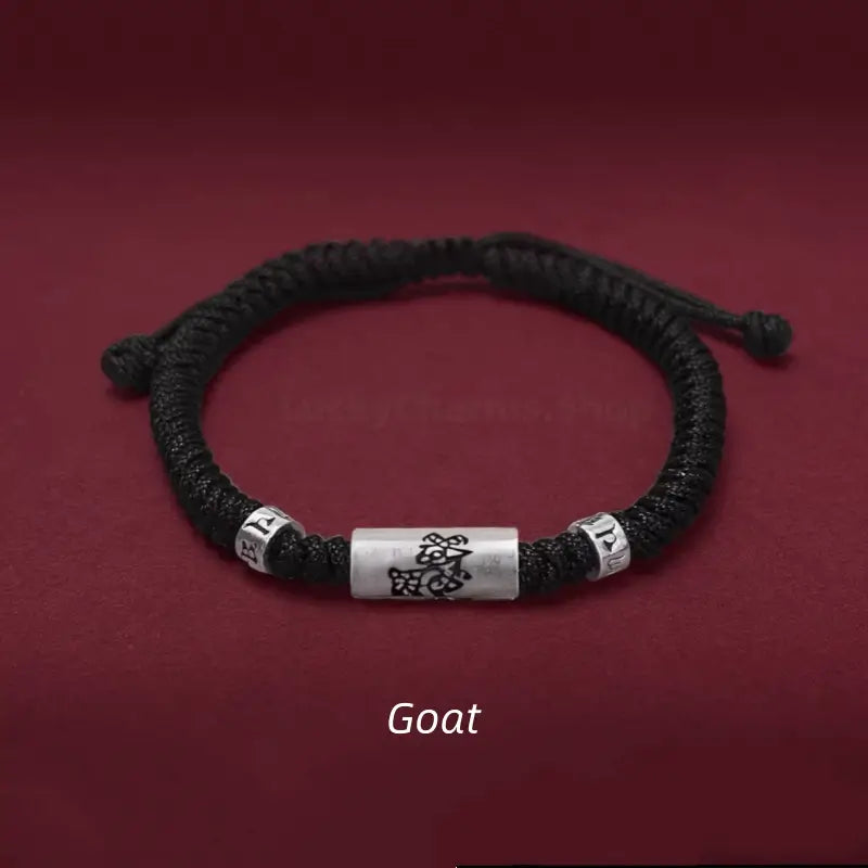 Chinese zodiac Goat men's black braided string bracelet with a 925 sterling silver LuLuTong mantra bead.