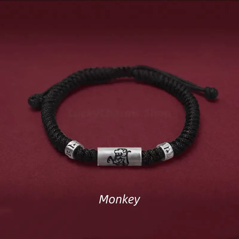 Chinese zodiac Monkey men's black braided rope bracelet with a 925 sterling silver LuLuTong mantra bead.