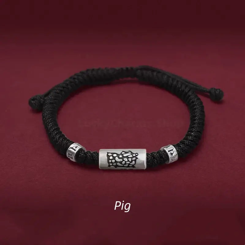 Chinese zodiac Pig men's black braided string bracelet with a 925 sterling silver LuLuTong mantra bead.