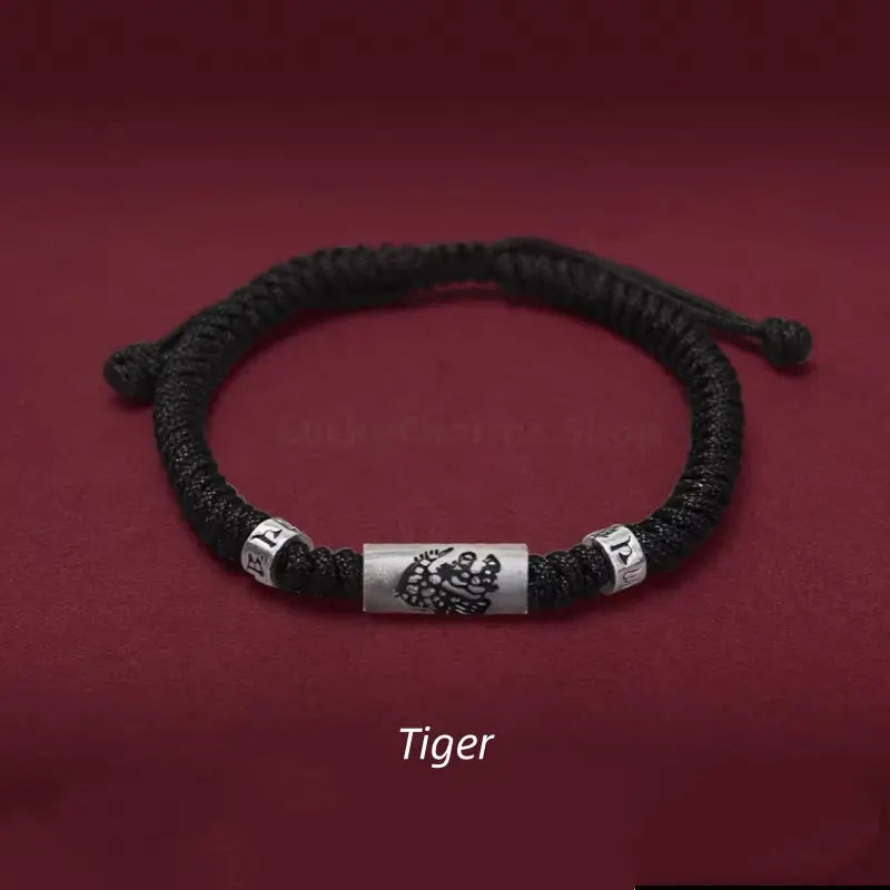Chinese zodiac Tiger men's black braided rope bracelet with a 925 sterling silver LuLuTong mantra tube bead.