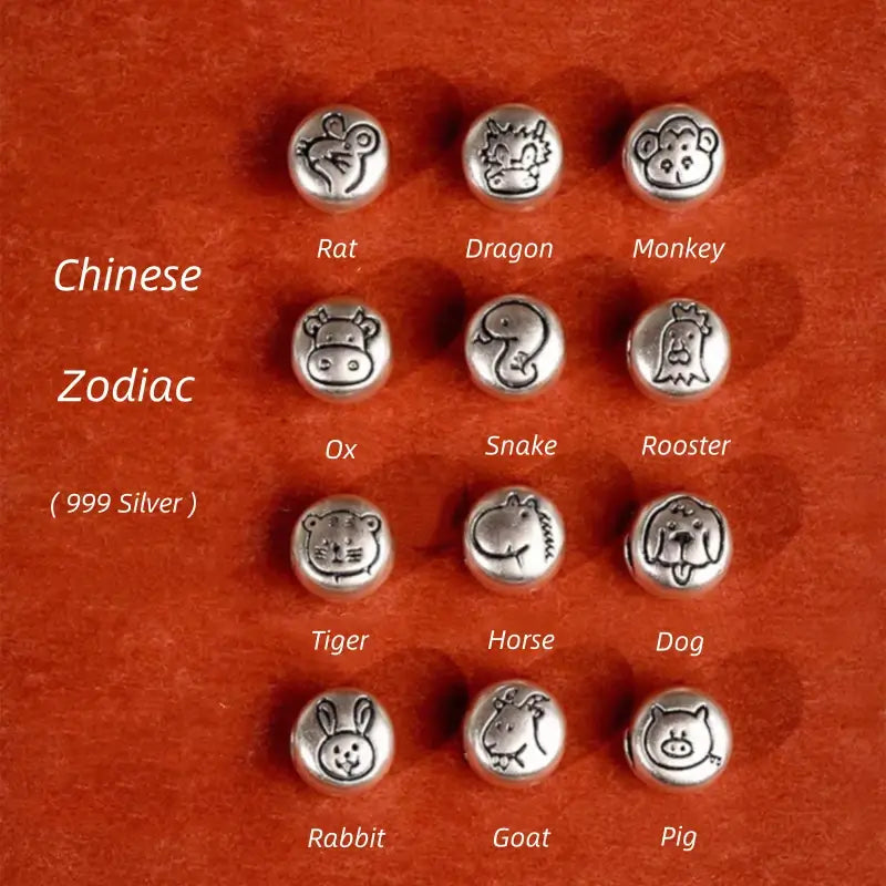 Collection of twelve 999 fine silver Chinese zodiac round charm beads with engraved animal icons.