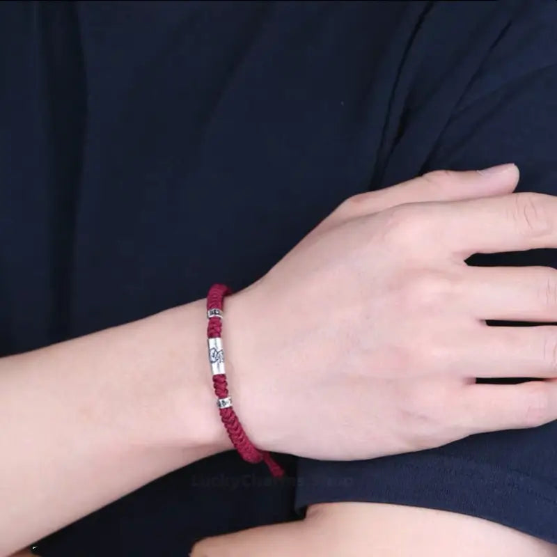 Man wearing 925 silver Chinese zodiac Lu Lu Tong red string bracelet with six-syllable mantra.