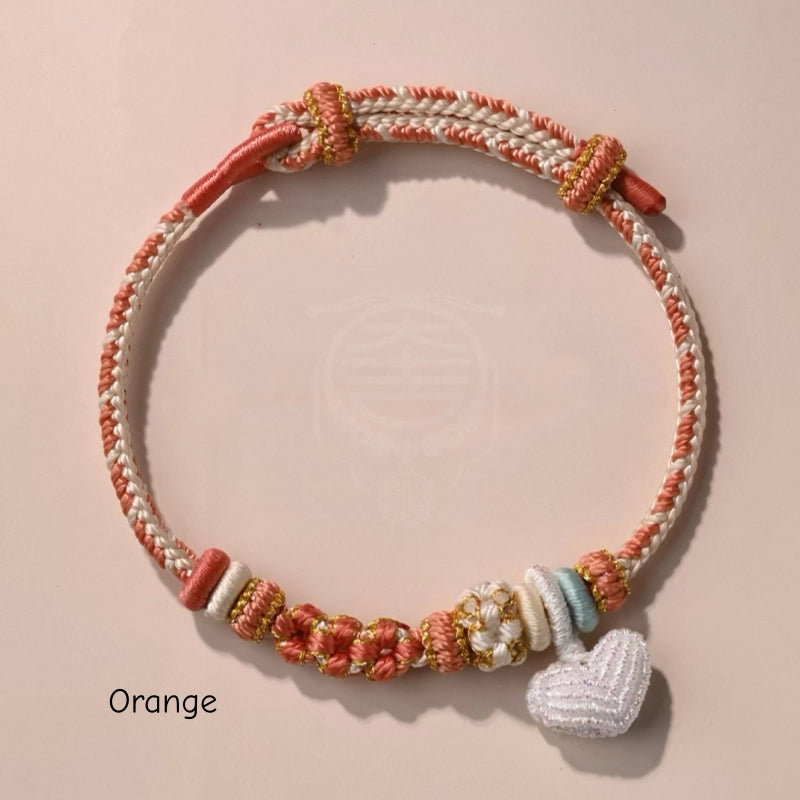 Handgefertigtes geflochtenes Pfirsichblüten-Knotenarmband mit Herzanhänger