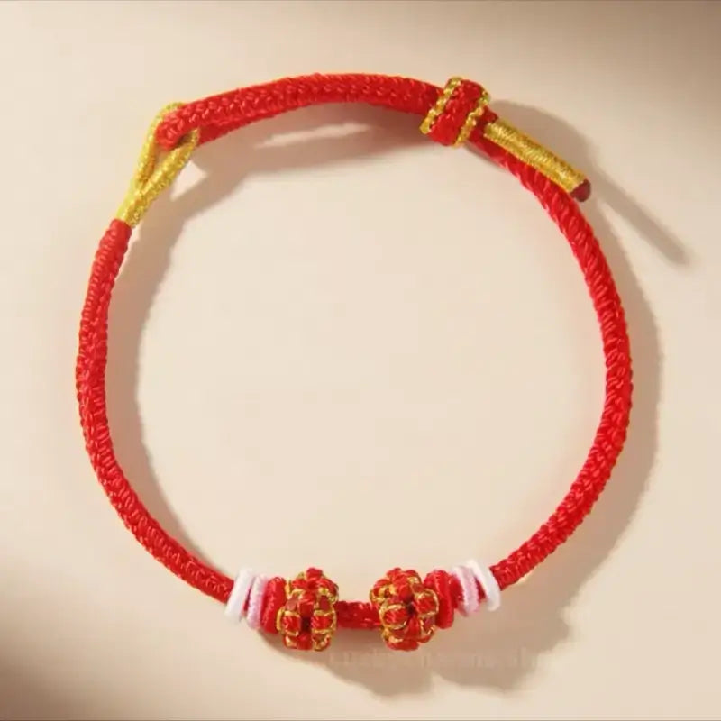 Classic red braided rope bracelet with decorative red peach blossom knots for DIY jewelry.