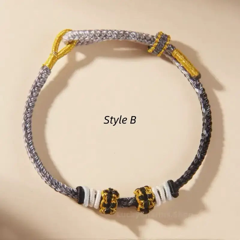 Style B grey and black braided thread cord bracelet with decorative gold-wrapped peach blossom knots.