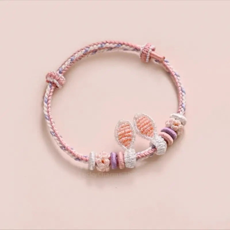 Pastel pink and purple handmade braided rabbit ear rope bracelet for DIY jewelry.