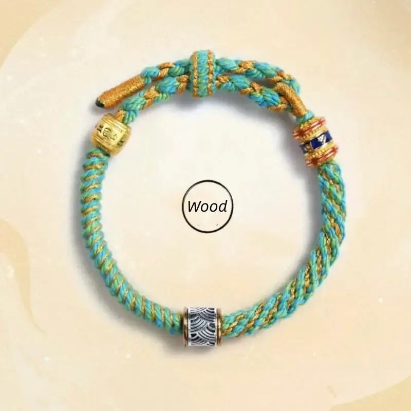 Wood style turquoise braided Five Elements guardian bracelet with silver wave charm and gold beads.