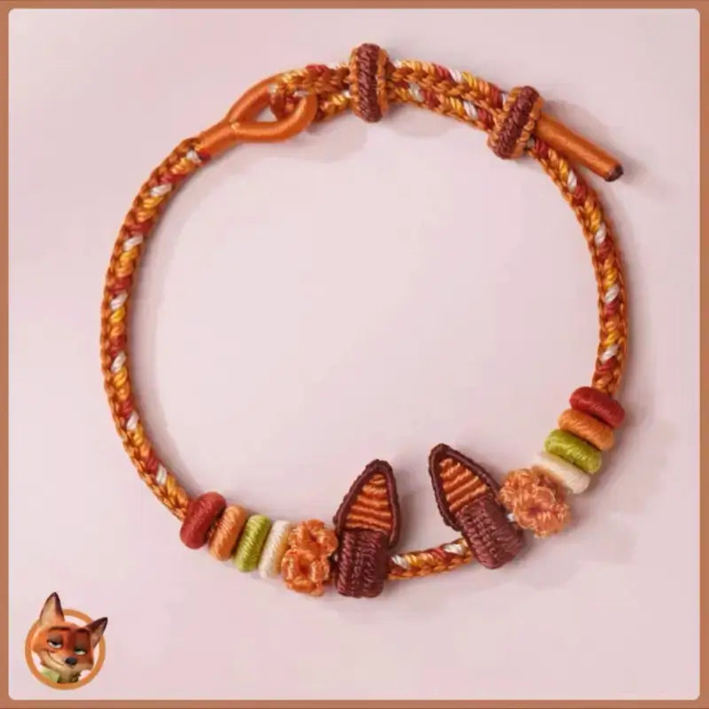 Handmade braided orange and yellow rope bracelet with woven Nick fox ears charm and loop closure.