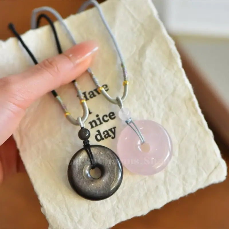 Couple set of natural silver obsidian and pink rose quartz peace buckle donut pendants.