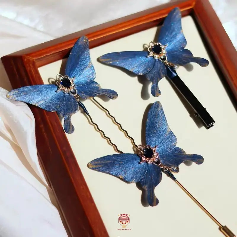 Traditional handmade velvet flower blue butterfly brooch, hairpin, and hair clip set in a frame.